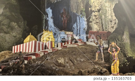 This is cave diorama features golden temples, ritual figures, and natural rock textures, blending Hindu symbolism in Batu Cave inside This is cave diorama features golden temples, ritual figures, and natural rock textures, blending Hindu symbolism in Batu Cave inside 135163703