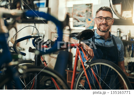Portrait, happy and repair man in bicycle shop for working in store, cycling workshop and startup. Confident bike mechanic, small business owner and mature male technician with glasses in Australia 135163771