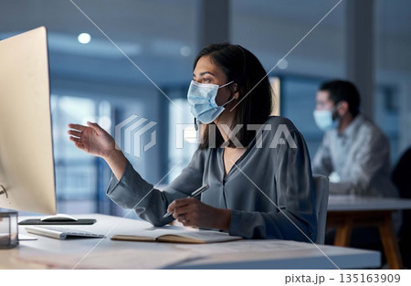 Call center, woman and mask at computer for customer service, telemarketing notes and CRM consulting at night. Female agent, desktop and virus protection for online support, questions and help desk Call center, woman and mask at computer for customer service, telemarketing notes and CRM consulting at night. Female agent, desktop and virus protection for online support, questions and help desk 135163909