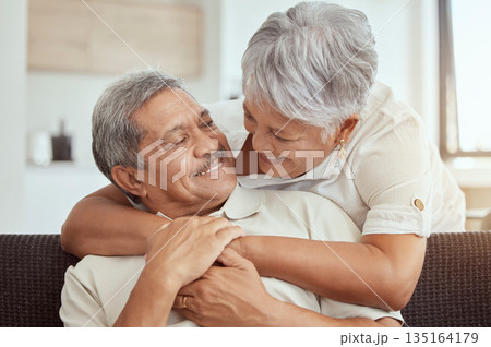 Love, hug and elderly couple on a sofa, happy and relax, laughing and talking their home together. Embrace, smile and senior man with woman on couch in a living room, cheerful and enjoying retirement Love, hug and elderly couple on a sofa, happy and relax, laughing and talking their home together. Embrace, smile and senior man with woman on couch in a living room, cheerful and enjoying retirement 135164179