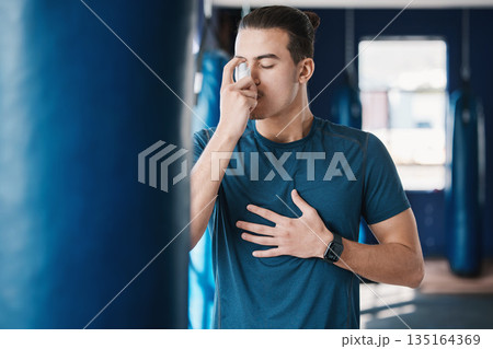 Asthma pump, breathe and man with fitness, medicine and wellness spray for health. Breathing, inhaler and lung relief with a male person in a gym with workout and medical problem support for care 135164369