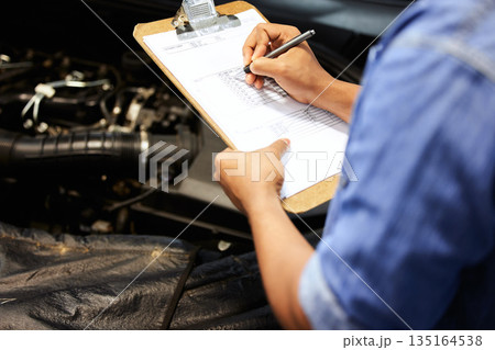 Hands, car mechanic and writing on checklist for service, maintenance and document repair list. Hand, man and engineer with vehicle inspection survey, report and checking engine motor in garage Hands, car mechanic and writing on checklist for service, maintenance and document repair list. Hand, man and engineer with vehicle inspection survey, report and checking engine motor in garage 135164538