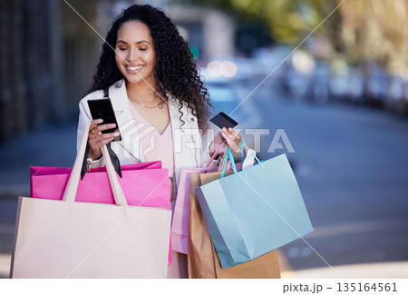 Shopping bag, phone and credit card with woman in city for digital payment, fintech and ecommerce app. Fashion, retail and finance with female customer in street for luxury, sale and online banking 135164561