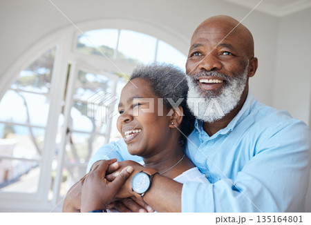 Senior black couple, hug and together in a home with love, care and commitment. Face of african woman and man thinking about happy marriage, retirement lifestyle and happiness or life insurance 135164801