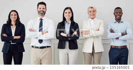 Portrait, collaboration and arms crossed with a diverse leadership team standing in their professional office. Business, teamwork and management with a group of colleagues looking confident at work 135165001
