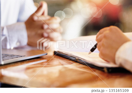Hands, notebook and writing with a human resources interview for a job opportunity or vacancy. Flare, hiring and recruitment with an hr manager meeting a candidate for business growth or development 135165109