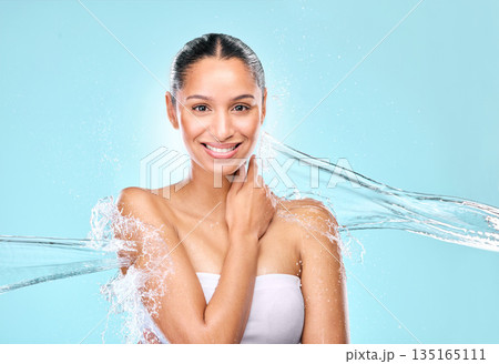 Water, splash and skincare with portrait of woman in studio for hygiene, beauty and shower. Wellness, cleaning and fresh with female model on blue background for spa, cosmetics and mockup space 135165111