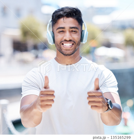Happy man, headphones and listening to music with thumbs up for winning, fitness or success in city. Portrait of male person, athlete or runner with headset, thumb emoji or yes sign for audio track Happy man, headphones and listening to music with thumbs up for winning, fitness or success in city. Portrait of male person, athlete or runner with headset, thumb emoji or yes sign for audio track 135165299