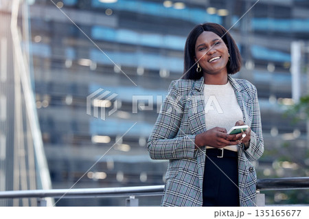 Portrait, business phone and black woman in city, urban street or outdoor. Face, smartphone and female professional, entrepreneur or person from South Africa on mobile app, social media and happy. Portrait, business phone and black woman in city, urban street or outdoor. Face, smartphone and female professional, entrepreneur or person from South Africa on mobile app, social media and happy. 135165677