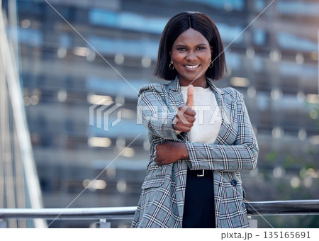 Portrait, thumbs up and black woman smile in city for business, support or outdoor success. Face, like hand gesture and African female professional with emoji for winner, goal or thank you for vote. 135165691