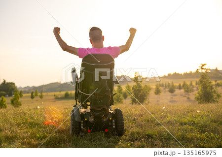 Disabled man raising his hands with confidence, expressing happiness, achievement, and positivity. 135165975
