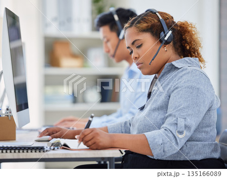Telemarketing, business woman and contact us writing in a office with paperwork at desk. Call center, African female employee and consulting of a worker with web support and agent advice notes 135166089