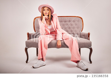 Portrait, fashion and confident woman on sofa in studio isolated on a white background mockup. Serious, stylish and female model on couch or chair from Brazil with cool clothes, pink hat and relax. Portrait, fashion and confident woman on sofa in studio isolated on a white background mockup. Serious, stylish and female model on couch or chair from Brazil with cool clothes, pink hat and relax. 135166358