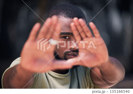 Hand frame, style and portrait of a black man in a city with fashion, styling and modern clothing. African male person, urban and hands of a model from Texas with gen z, cool and hipster shirt Hand frame, style and portrait of a black man in a city with fashion, styling and modern clothing. African male person, urban and hands of a model from Texas with gen z, cool and hipster shirt 135166540