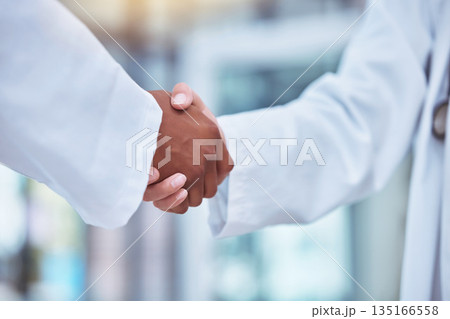 Closeup, doctors and handshake in hospital for partnership, deal and collaboration for wellness, healthcare and respect. Medic team, shaking hands and welcome for interview, hiring and recruitment Closeup, doctors and handshake in hospital for partnership, deal and collaboration for wellness, healthcare and respect. Medic team, shaking hands and welcome for interview, hiring and recruitment 135166558