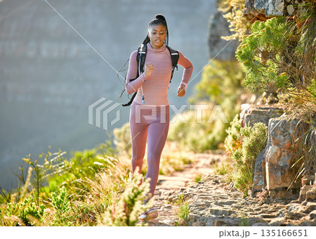 Black woman, mountain running and outdoor for fitness, speed or challenge for wellness with focus in summer. African girl, workout and runner training in sunshine with exercise, adventure and hiking Black woman, mountain running and outdoor for fitness, speed or challenge for wellness with focus in summer. African girl, workout and runner training in sunshine with exercise, adventure and hiking 135166651