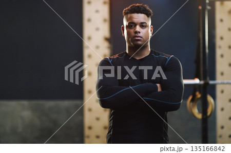Crossed arms, exercise and portrait of man in gym for training, fitness and bodybuilder workout. Motivation, muscles and serious male person in sports center for challenge, wellness and body strength Crossed arms, exercise and portrait of man in gym for training, fitness and bodybuilder workout. Motivation, muscles and serious male person in sports center for challenge, wellness and body strength 135166842