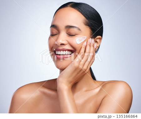 Beauty cream, woman and skincare smile with dermatology and face cleaning. Wellness, cosmetic lotion and young female model with skin glow product and treatment with care and laugh in studio Beauty cream, woman and skincare smile with dermatology and face cleaning. Wellness, cosmetic lotion and young female model with skin glow product and treatment with care and laugh in studio 135166864