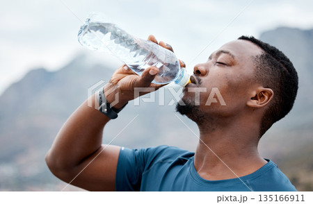Drinking water, fitness and black man in nature for exercise, marathon training and running outdoors. Sports, workout and thirsty male person rest to drink liquid for hydration, wellness and health Drinking water, fitness and black man in nature for exercise, marathon training and running outdoors. Sports, workout and thirsty male person rest to drink liquid for hydration, wellness and health 135166911