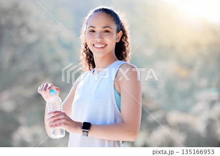 Happy woman, portrait smile and water in fitness for sustainability, hydration or break from running in nature. Fit, active and sporty female person or runner smiling with bottle for thirst in run Happy woman, portrait smile and water in fitness for sustainability, hydration or break from running in nature. Fit, active and sporty female person or runner smiling with bottle for thirst in run 135166953