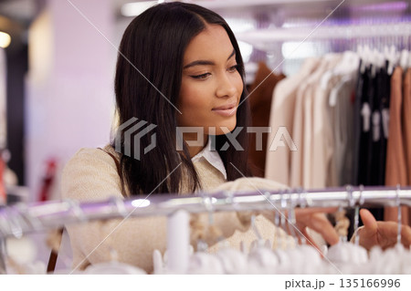 Shopping, fashion and woman with clothes in store for sale, discount and bargain for style. Retail boutique, mall and female person browse clothing on rack for purchase choice, decision and search 135166996
