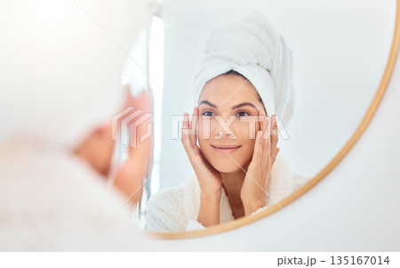 Mirror, woman and hands on face for skincare, check and anti aging cosmetic results in bathroom. Facial, beauty and female touching soft, glow and smooth skin after luxury dermatology routine at home 135167014