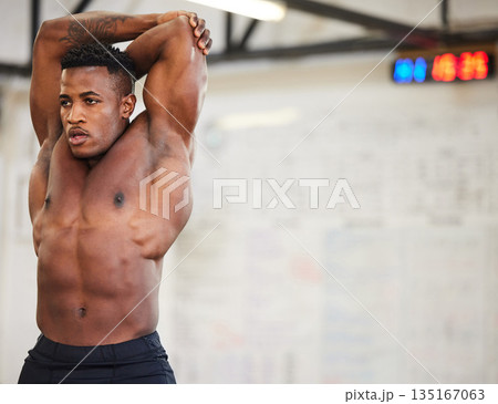 Shirtless black man, stretching and fitness in gym with muscle, strong and abs with workout and mockup space. Serious male athlete, bodybuilder with warm up and ready for exercise with muscular arms Shirtless black man, stretching and fitness in gym with muscle, strong and abs with workout and mockup space. Serious male athlete, bodybuilder with warm up and ready for exercise with muscular arms 135167063