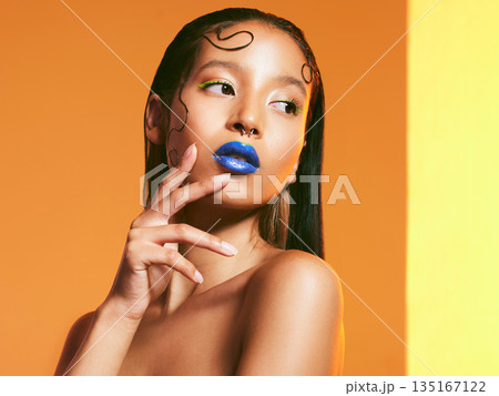 Cosmetics, blue lipstick and face of woman in studio for makeup, eye shadow and beauty salon. Creative aesthetic, cosmetology and female person with neon color for glamour, luxury style and glow Cosmetics, blue lipstick and face of woman in studio for makeup, eye shadow and beauty salon. Creative aesthetic, cosmetology and female person with neon color for glamour, luxury style and glow 135167122