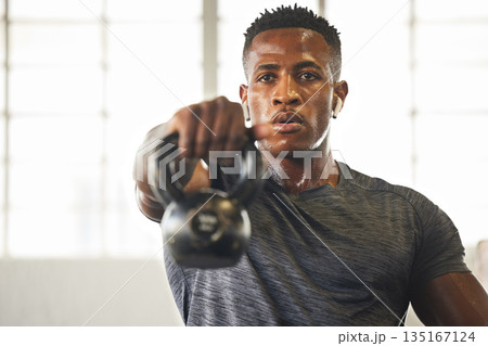 Kettlebell, fitness and black man with gym workout, bodybuilder challenge and training with health and focus. Young athlete or professional person sweating for sports exercise, muscle and power goals Kettlebell, fitness and black man with gym workout, bodybuilder challenge and training with health and focus. Young athlete or professional person sweating for sports exercise, muscle and power goals 135167124