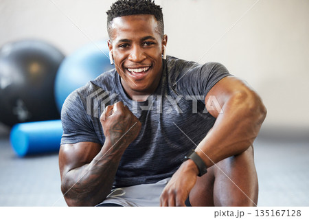 Fitness, cheering and portrait of man in a gym after success or complete workout. Sports, motivation and African male athlete with fist pump for bodybuilding or strength arm exercise in sport center. Fitness, cheering and portrait of man in a gym after success or complete workout. Sports, motivation and African male athlete with fist pump for bodybuilding or strength arm exercise in sport center. 135167128
