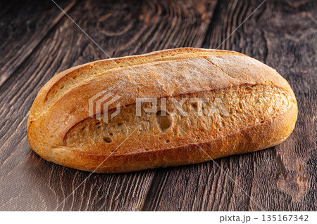 Rustic crusty brown loaf bread Rustic crusty brown loaf bread 135167342
