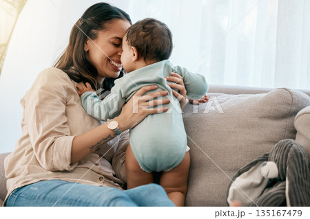 Love, happy and mother with baby on a sofa for playing, games and laughing in their home together. Family, smile and mom with girl toddler on a couch, relax and bonding, fun and hug in a living room Love, happy and mother with baby on a sofa for playing, games and laughing in their home together. Family, smile and mom with girl toddler on a couch, relax and bonding, fun and hug in a living room 135167479