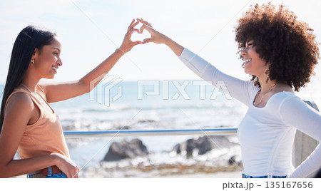 Friends, heart and hands with women at beach for summer, happy and teamwork. Support, freedom and love with people and holding shape in outdoors for collaboration, faith and community gesture Friends, heart and hands with women at beach for summer, happy and teamwork. Support, freedom and love with people and holding shape in outdoors for collaboration, faith and community gesture 135167656