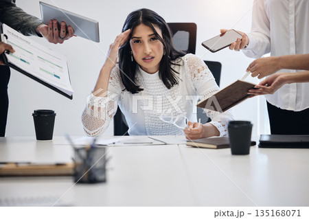 Portrait, multitask and an overwhelmed business woman at work on a laptop in an office for a deadline. Technology, stress or anxiety with a young female employee feeling pressure from a busy schedule 135168071