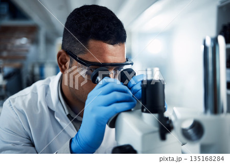 Man, scientist and microscope in forensic science research, discovery or data analysis at lab. Male person or medical professional in scientific results for cure, virus or vaccine in laboratory 135168284