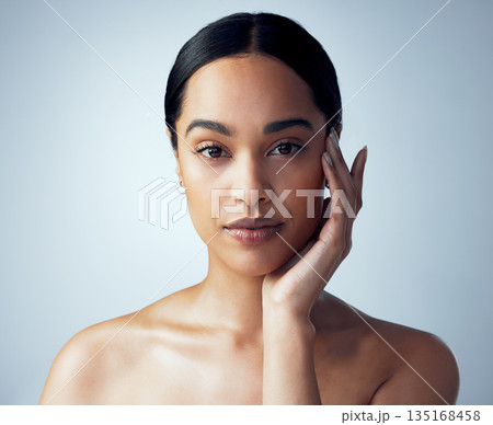 Skincare, portrait and woman in studio for natural, cosmetic and dermatology on grey background. Face, beauty and female model touching soft, smooth and glowing skin after luxury self care routine 135168458