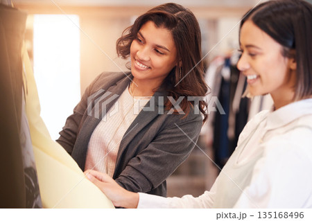 Fashion, retail and customer friends shopping in a mall together while searching for sales in a clothing store. Consumerism, smile, or happy with a woman and friend in a boutique shop to buy clothes Fashion, retail and customer friends shopping in a mall together while searching for sales in a clothing store. Consumerism, smile, or happy with a woman and friend in a boutique shop to buy clothes 135168496