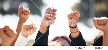Closeup, group and protest with solidarity, hands and support for human rights, equality or freedom. Zoom, community or protesters with teamwork, activism or union with empowerment, outdoor and crowd 135168640
