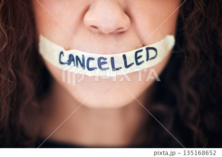 Political, protest and closeup with tape on a mouth for justice, freedom or revolution movement. Bullying, violence and zoom of a woman with cancelled on lips for feminism, activism or discrimination Political, protest and closeup with tape on a mouth for justice, freedom or revolution movement. Bullying, violence and zoom of a woman with cancelled on lips for feminism, activism or discrimination 135168652