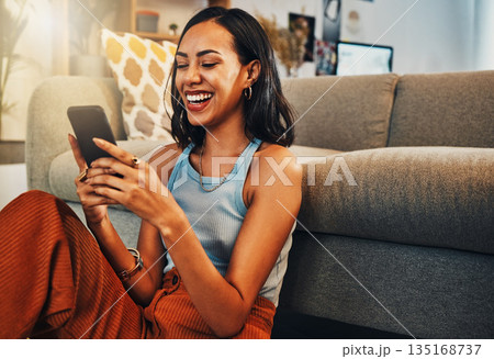 Woman laughing at chat on smartphone, social media and funny meme with communication and technology. Female person relax at home, using phone and comedy online with streaming and texting on app Woman laughing at chat on smartphone, social media and funny meme with communication and technology. Female person relax at home, using phone and comedy online with streaming and texting on app 135168737