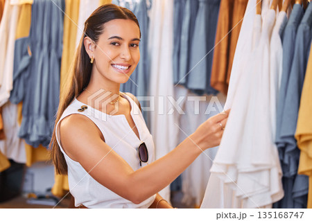 Shopping, clothes choice and a woman in boutique or mall for fashion, sale or discount deal. Portrait of female person or happy customer in retail store for promotion offer or luxury brand on hanger 135168747