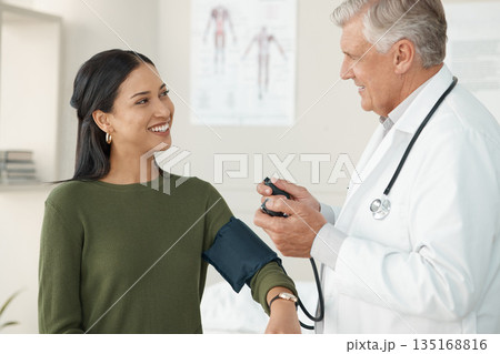 Senior doctor, blood pressure or patient in a consultation, wellness or appointment with results, checkup or talking. Healthcare, woman or medical physician with cuff for hypertension or examination 135168816