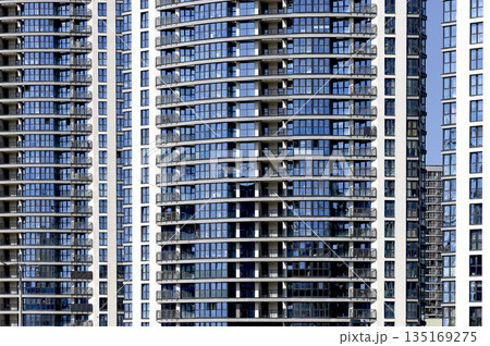 Window pattern on modern building. Contemporary urban architecture with symmetrical facades, Window pattern on modern building. Contemporary urban architecture with symmetrical facades, 135169275