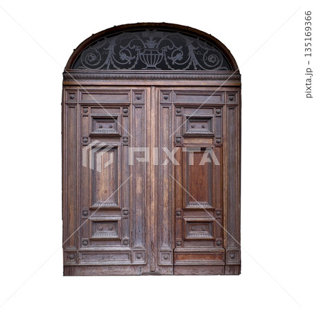 Door with antique carved wood. Old wooden arched entrance with weathered oak texture, vintage brown Door with antique carved wood. Old wooden arched entrance with weathered oak texture, vintage brown 135169366