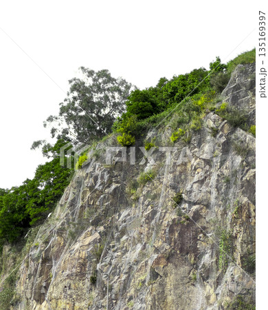 Rock cliff with rugged mountain terrain. Natural stone formation in green landscape with vegetation, Rock cliff with rugged mountain terrain. Natural stone formation in green landscape with vegetation, 135169397