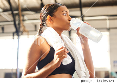 Relax, fitness or Indian woman drinking water in gym after training, workout or exercise to hydrate her body. Fatigue, wellness or tired girl with bottle for healthy liquid hydration on resting break Relax, fitness or Indian woman drinking water in gym after training, workout or exercise to hydrate her body. Fatigue, wellness or tired girl with bottle for healthy liquid hydration on resting break 135169424