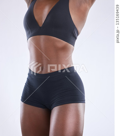Stomach, fitness and health with black woman in studio for nutrition, weight loss and diet. Beauty, wellness and body muscle with closeup of female model on white background for self care and glow Stomach, fitness and health with black woman in studio for nutrition, weight loss and diet. Beauty, wellness and body muscle with closeup of female model on white background for self care and glow 135169439