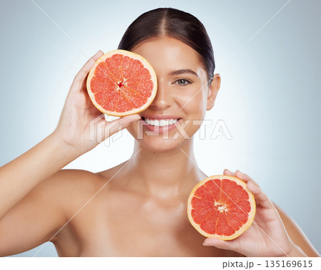 Skincare, face and woman smile with grapefruit in studio isolated on a white background. Portrait, natural and female model with fruit for vitamin c, nutrition and healthy diet, wellness or cosmetics Skincare, face and woman smile with grapefruit in studio isolated on a white background. Portrait, natural and female model with fruit for vitamin c, nutrition and healthy diet, wellness or cosmetics 135169615