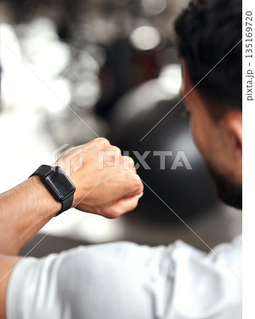 Fitness, app and man with smart watch, time and workout schedule online at gym and sports training. Athlete with digital application, heart rate tracker and tech for exercise and health on stopwatch. Fitness, app and man with smart watch, time and workout schedule online at gym and sports training. Athlete with digital application, heart rate tracker and tech for exercise and health on stopwatch. 135169720