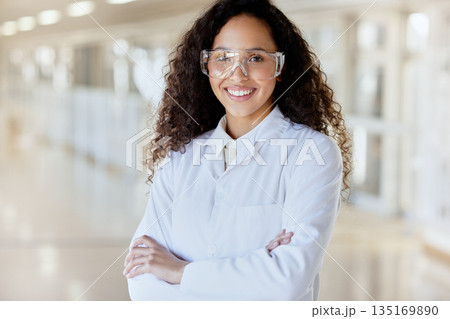 Science, laboratory and proud portrait of happy woman with goggles for safety in research study, development and biochemistry. Smile, chemistry job and professional female scientist with arms crossed 135169890